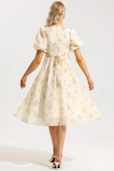 Cream-colored floral midi dress with ruched top
