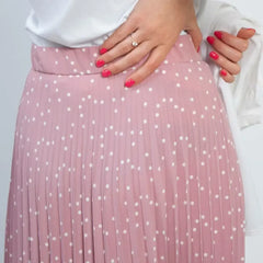 Pink pleated skirt with white polka dots