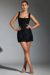 Black mini dress with three-dimensional pink details