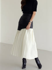 Pleated midi skirt with asymmetrical faux leather yoke