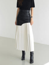 Pleated midi skirt with asymmetrical faux leather yoke