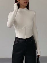 White fitted top with long sleeves and corset details