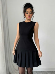 Black sleeveless mini dress with pleated skirt