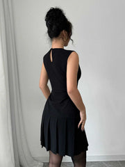 Black sleeveless mini dress with pleated skirt