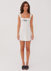 White mini dress with black bow detail
