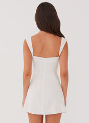 White mini dress with black bow detail