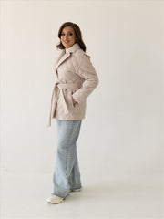 Beige quilted jacket with belt and shawl collar