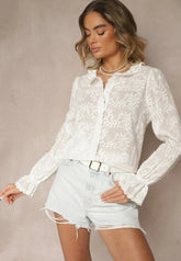 White embroidered blouse with ruffle trim at sleeves