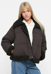 Dark brown short puffer jacket with black teddy collar and hem