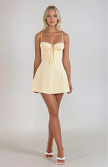 Light yellow strapless mini dress with bow