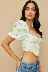 Elfenbensfärgad korsett med blommor och puffärmar