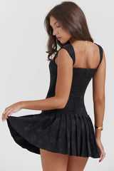 Black corset dress with lace and pleated skirt