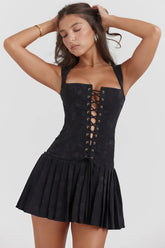 Black corset dress with lace and pleated skirt