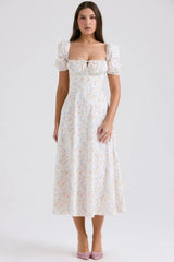 White midi dress with pastel floral pattern and puff sleeves