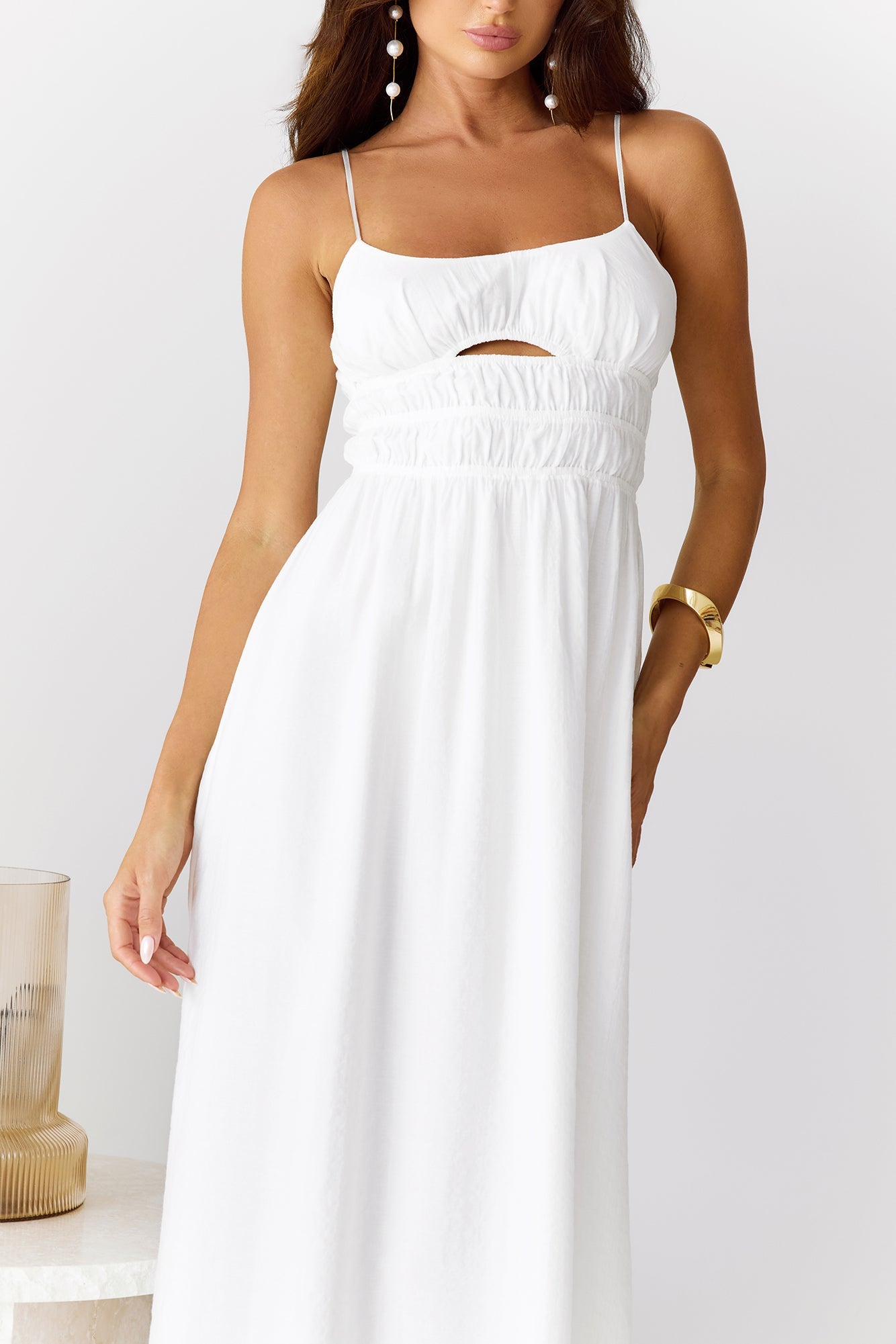 White long dress with narrow straps and hollow-out details