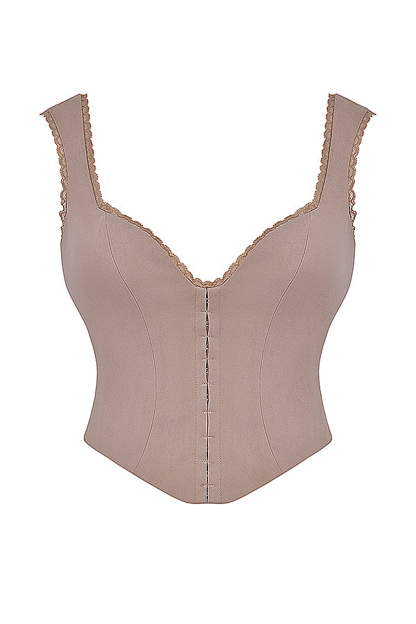 Korsett med spets framtill och kjol med utskuret ben