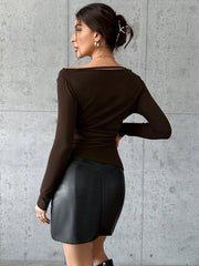 Chocolate brown long sleeve top with cutout neckline and asymmetrical hem