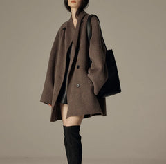 Oversized double-breasted coat with shawl collar.