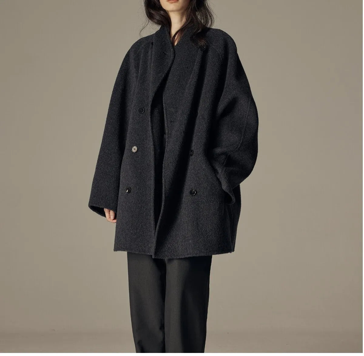 Oversized double-breasted coat with shawl collar.