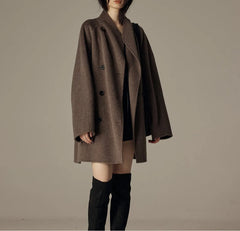 Oversized double-breasted coat with shawl collar.