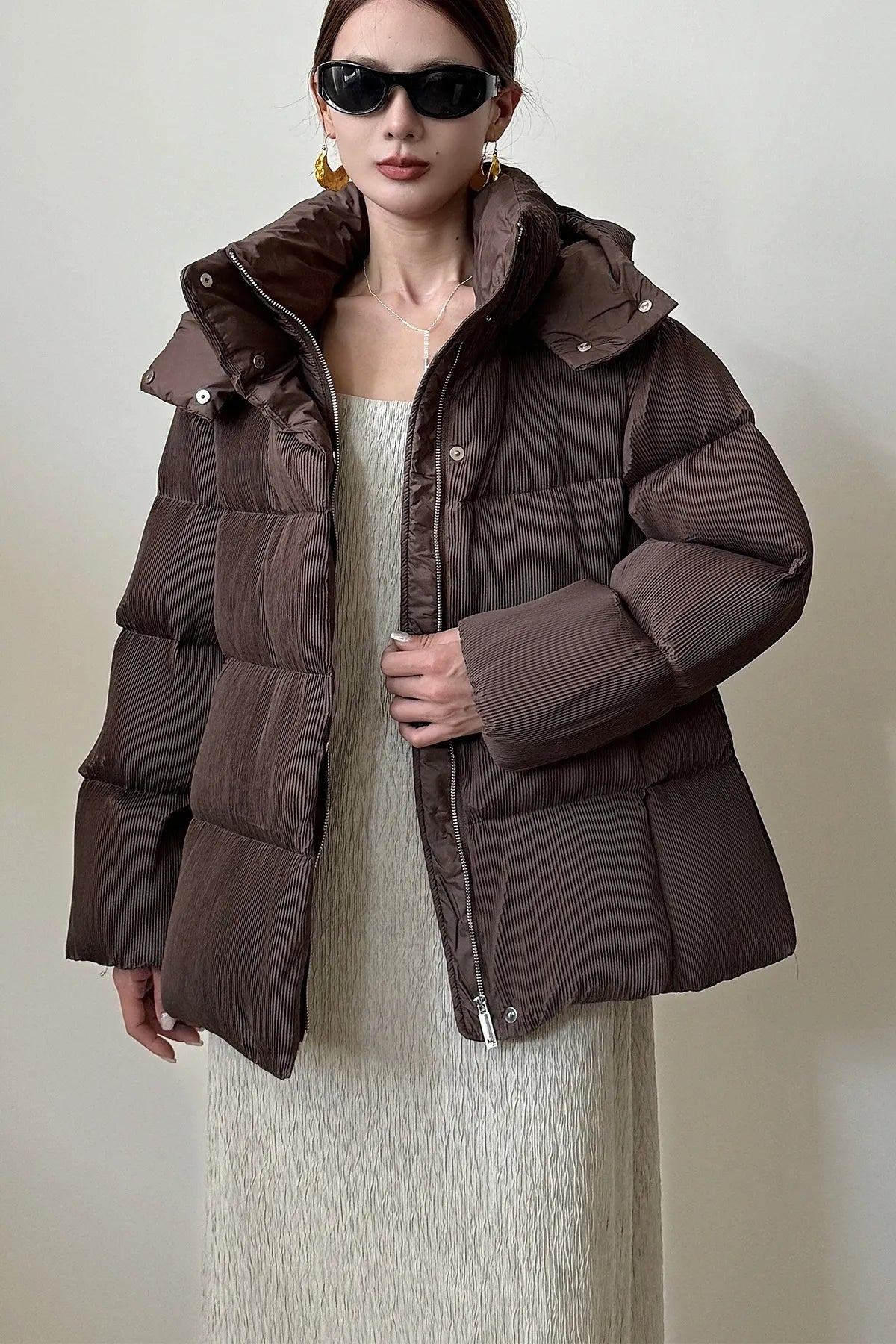 Puffer jacket with waist belt and high stand-up collar