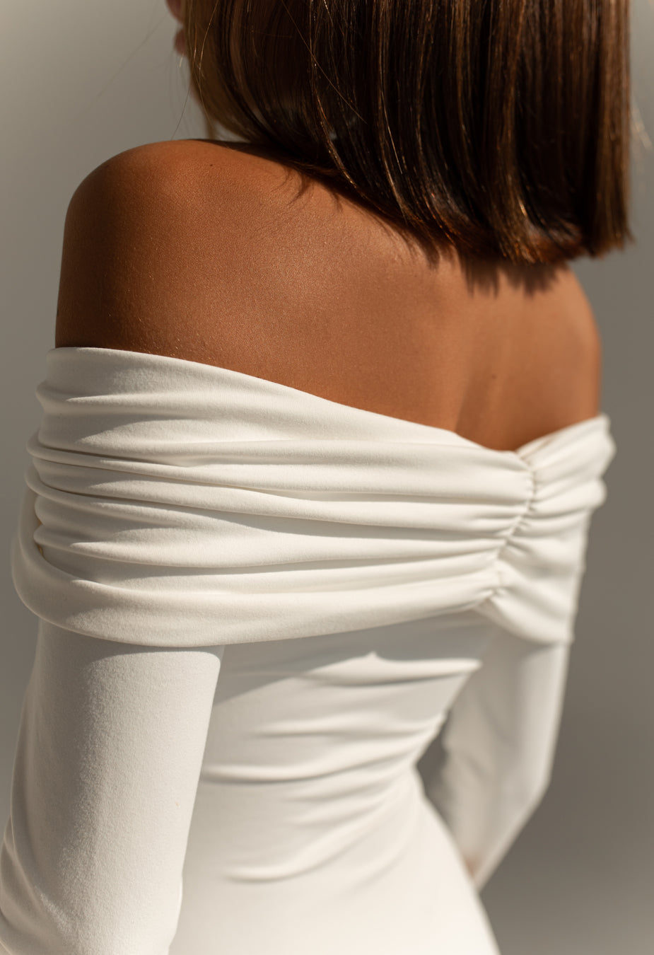 White off-the-shoulder long-sleeved bodysuit