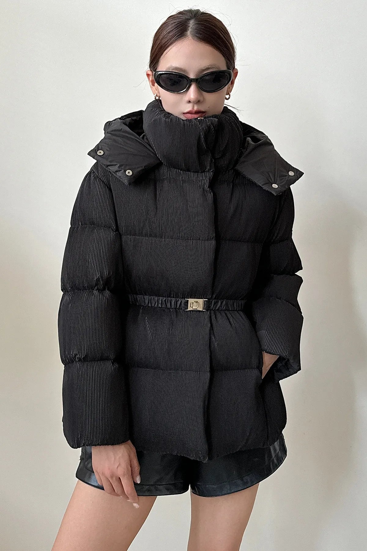Puffer jacket with waist belt and high stand-up collar
