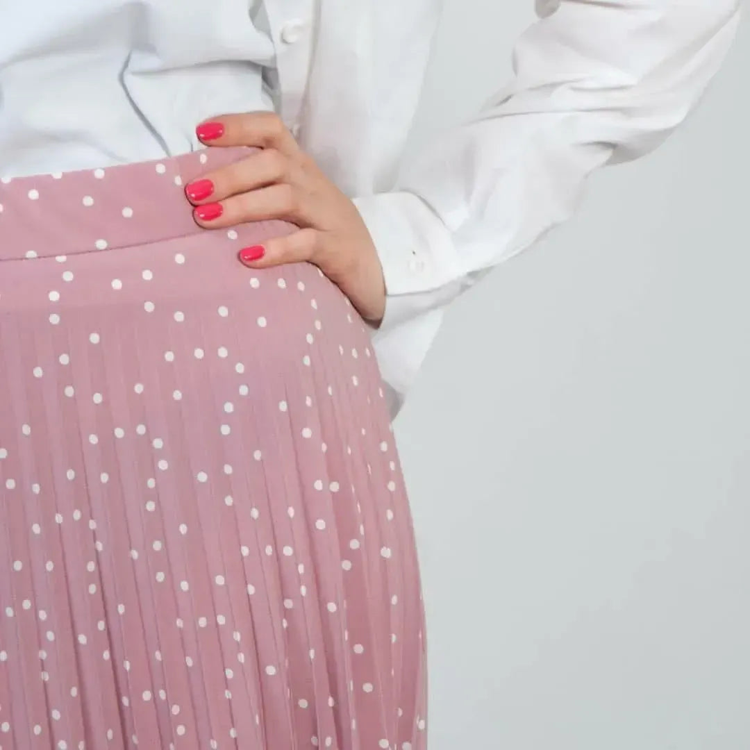 Pink pleated skirt with white polka dots