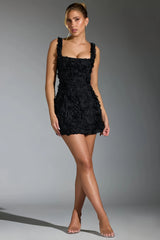 Black mini dress with three-dimensional pink details