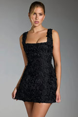 Black mini dress with three-dimensional pink details