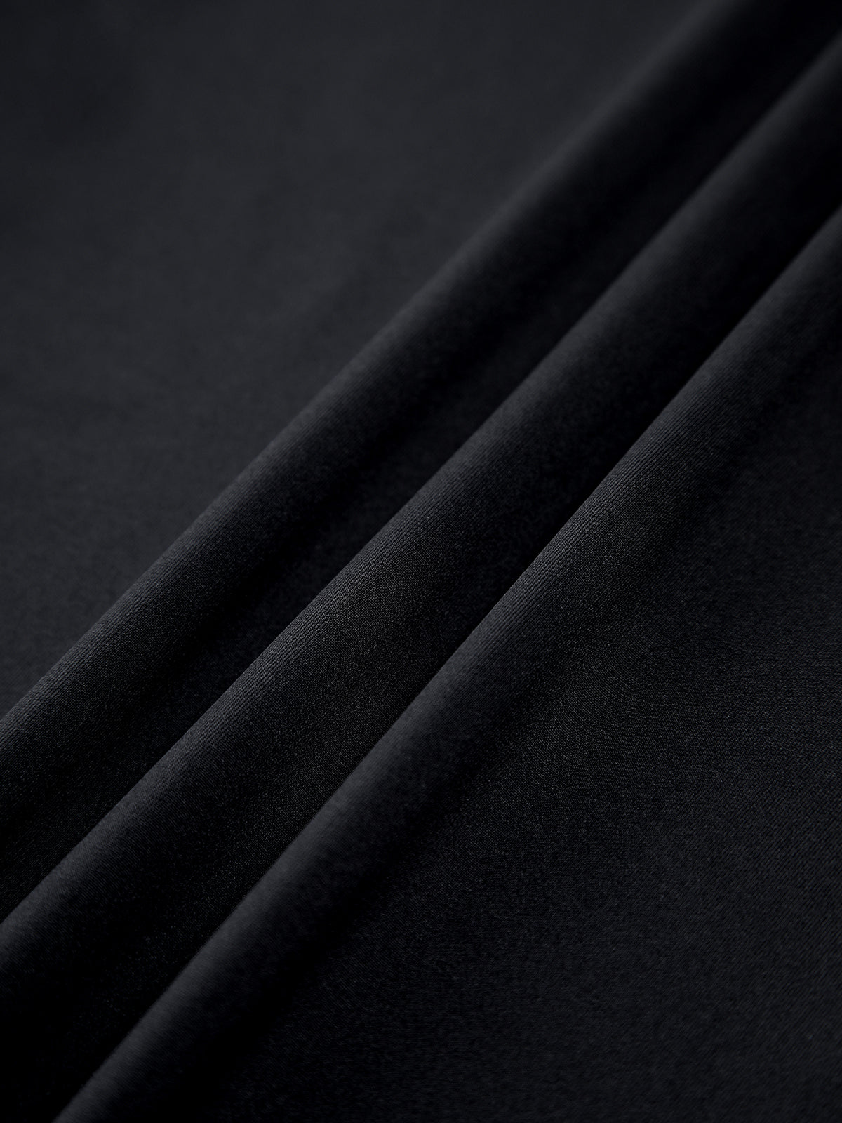 Black sleeveless crop top with high neck and pleated waist