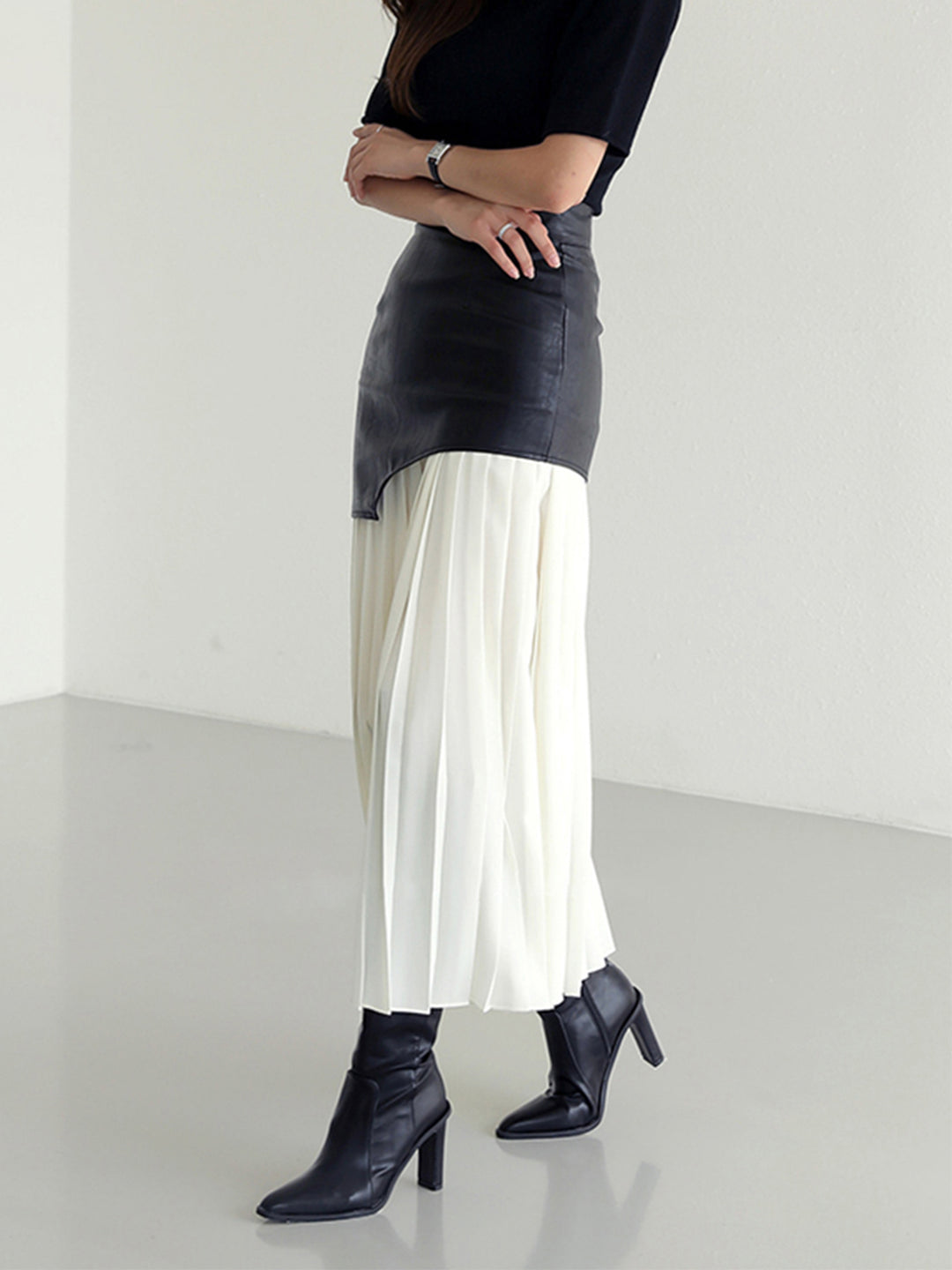 Pleated midi skirt with asymmetrical faux leather yoke