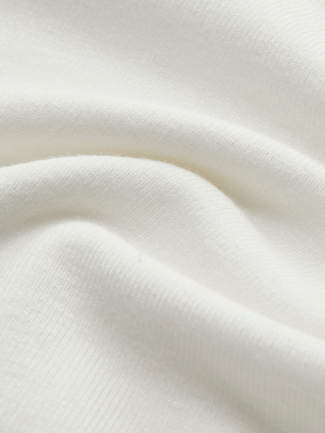 White fitted top with long sleeves and corset details