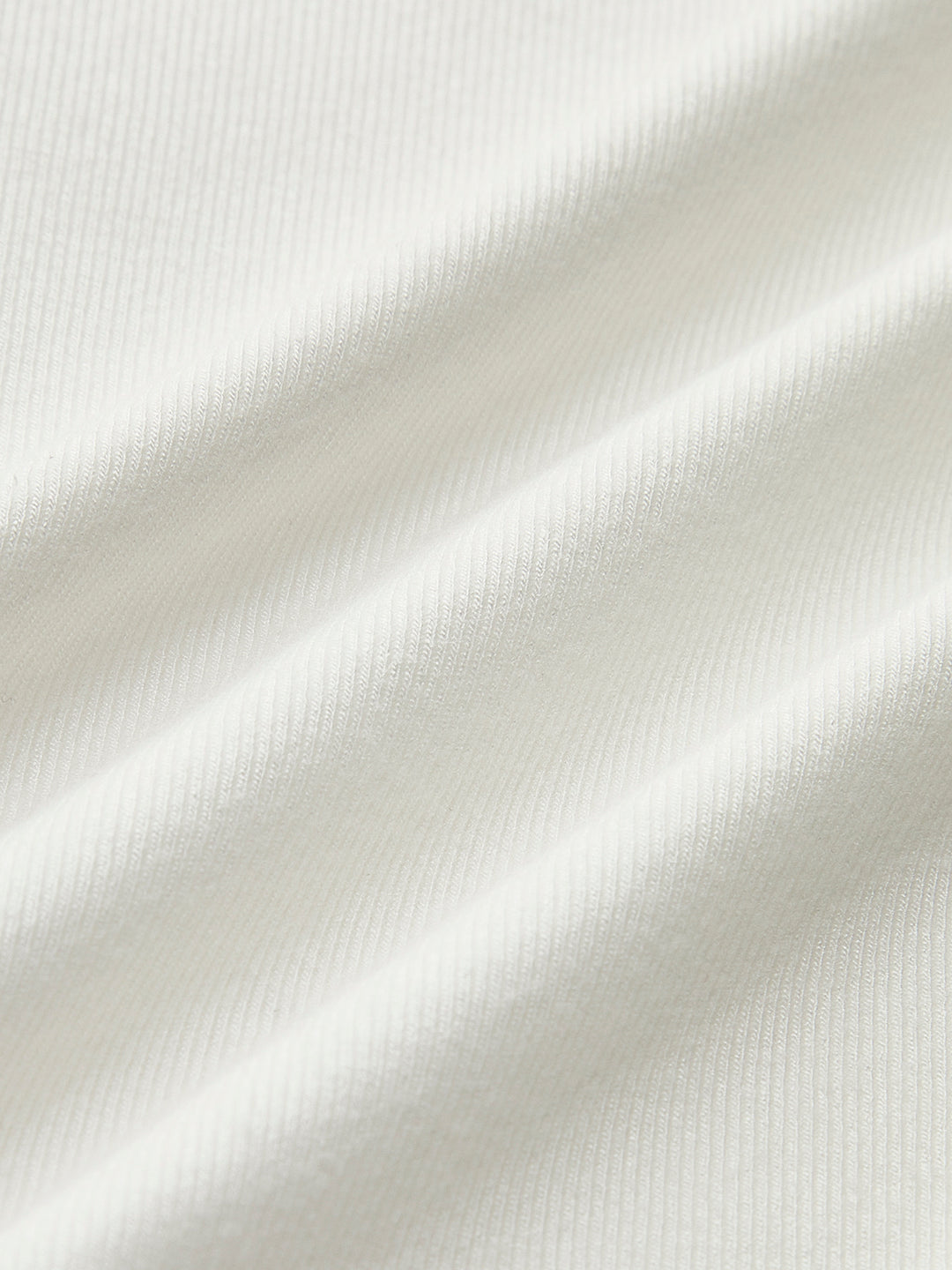 White fitted top with long sleeves and corset details