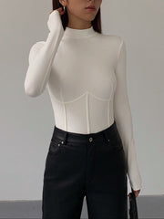 White fitted top with long sleeves and corset details