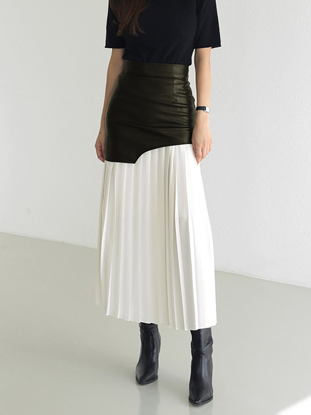 Pleated midi skirt with asymmetrical faux leather yoke