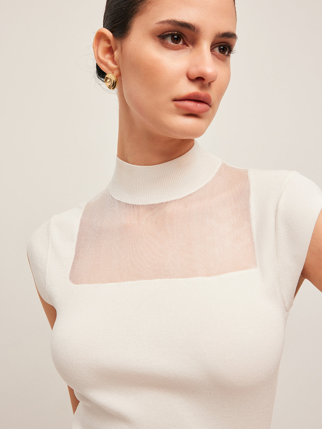 Sleeveless top with mesh details and high neck