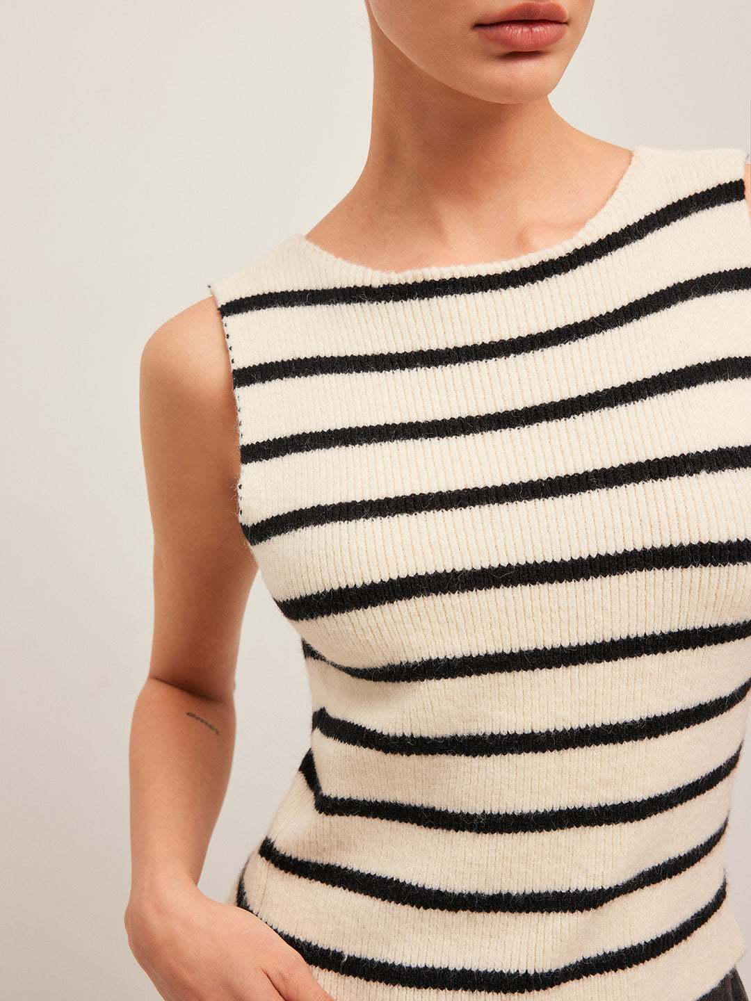 Sleeveless black and white striped knit top