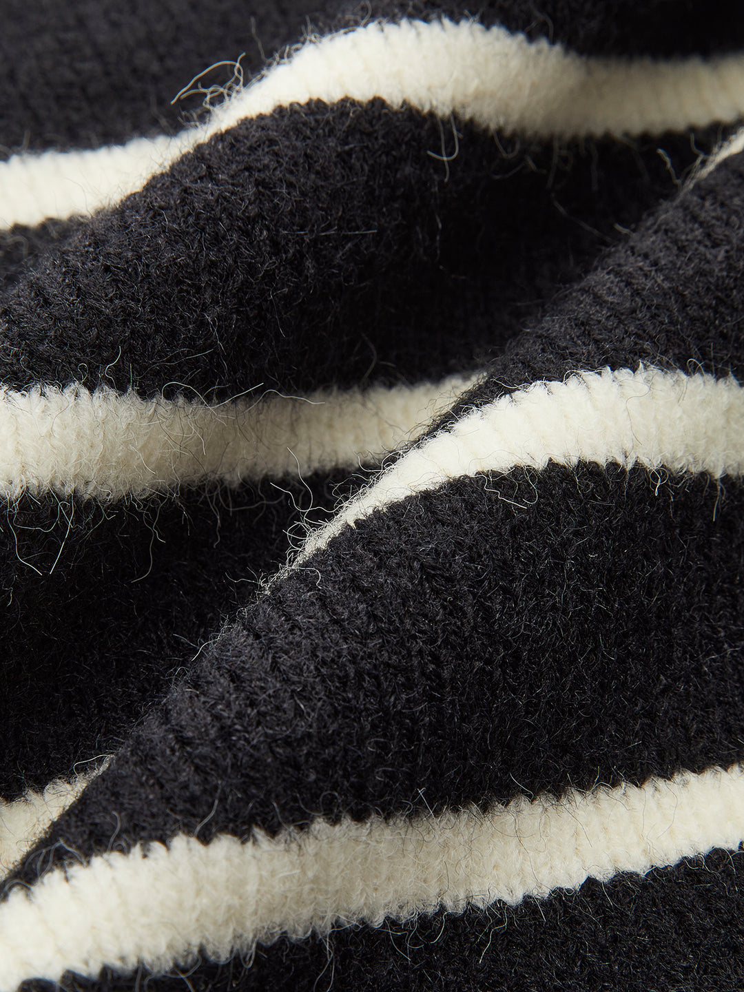 Sleeveless black and white striped knit top