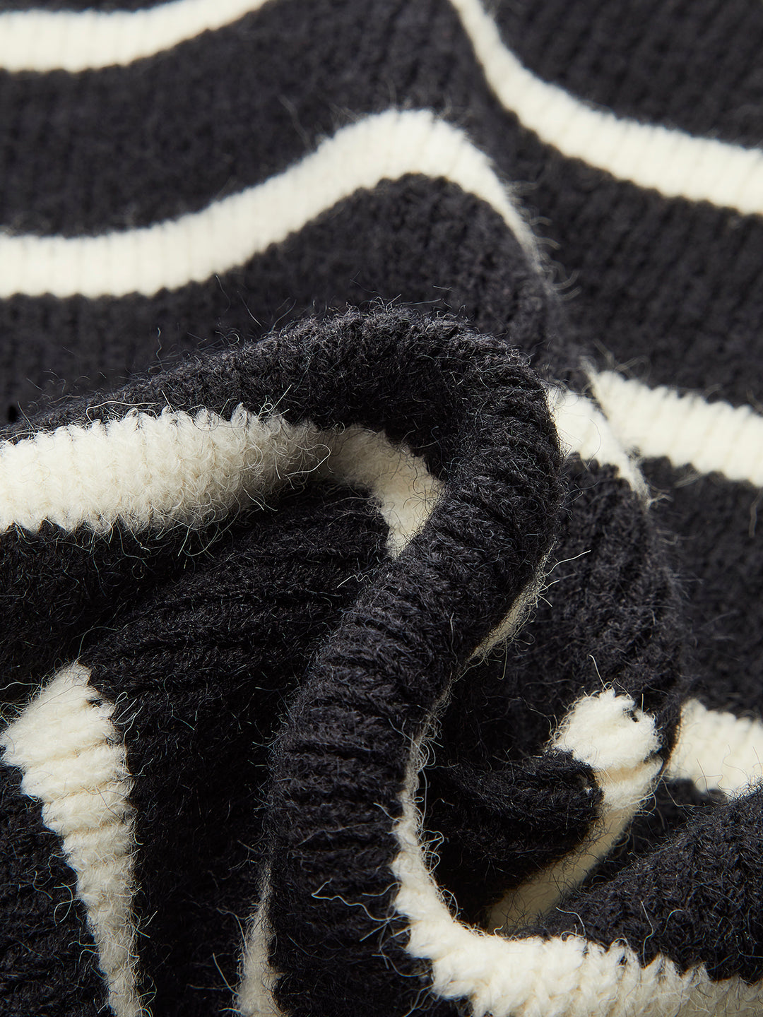 Sleeveless black and white striped knit top