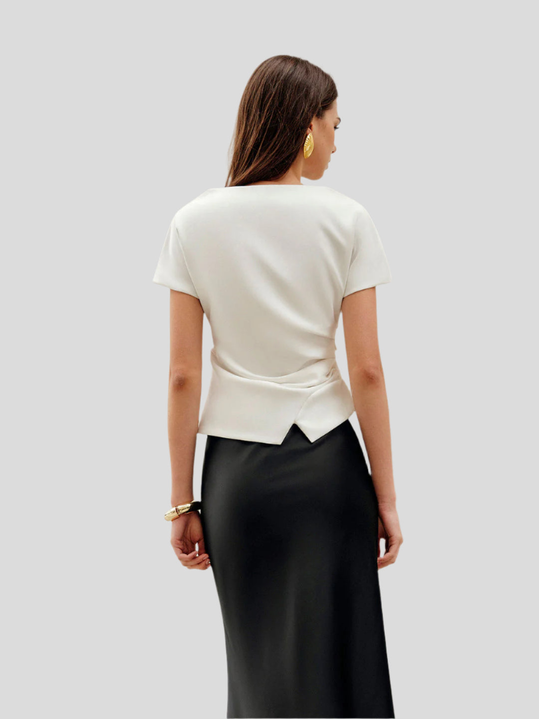 Draped top with asymmetrical hem