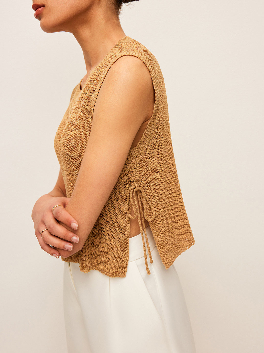 Beige knit sleeveless top with side lace closure