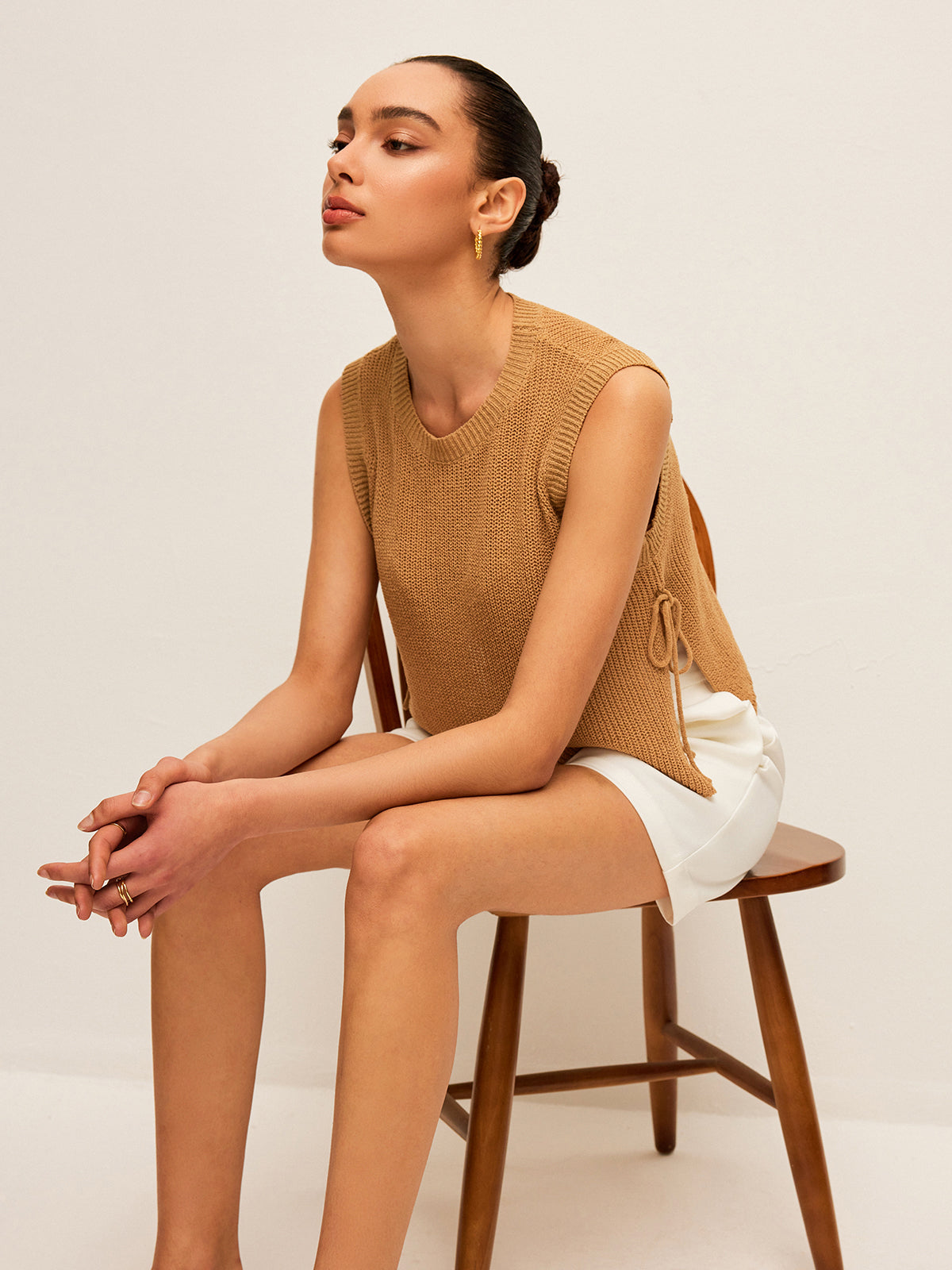 Beige knit sleeveless top with side lace closure