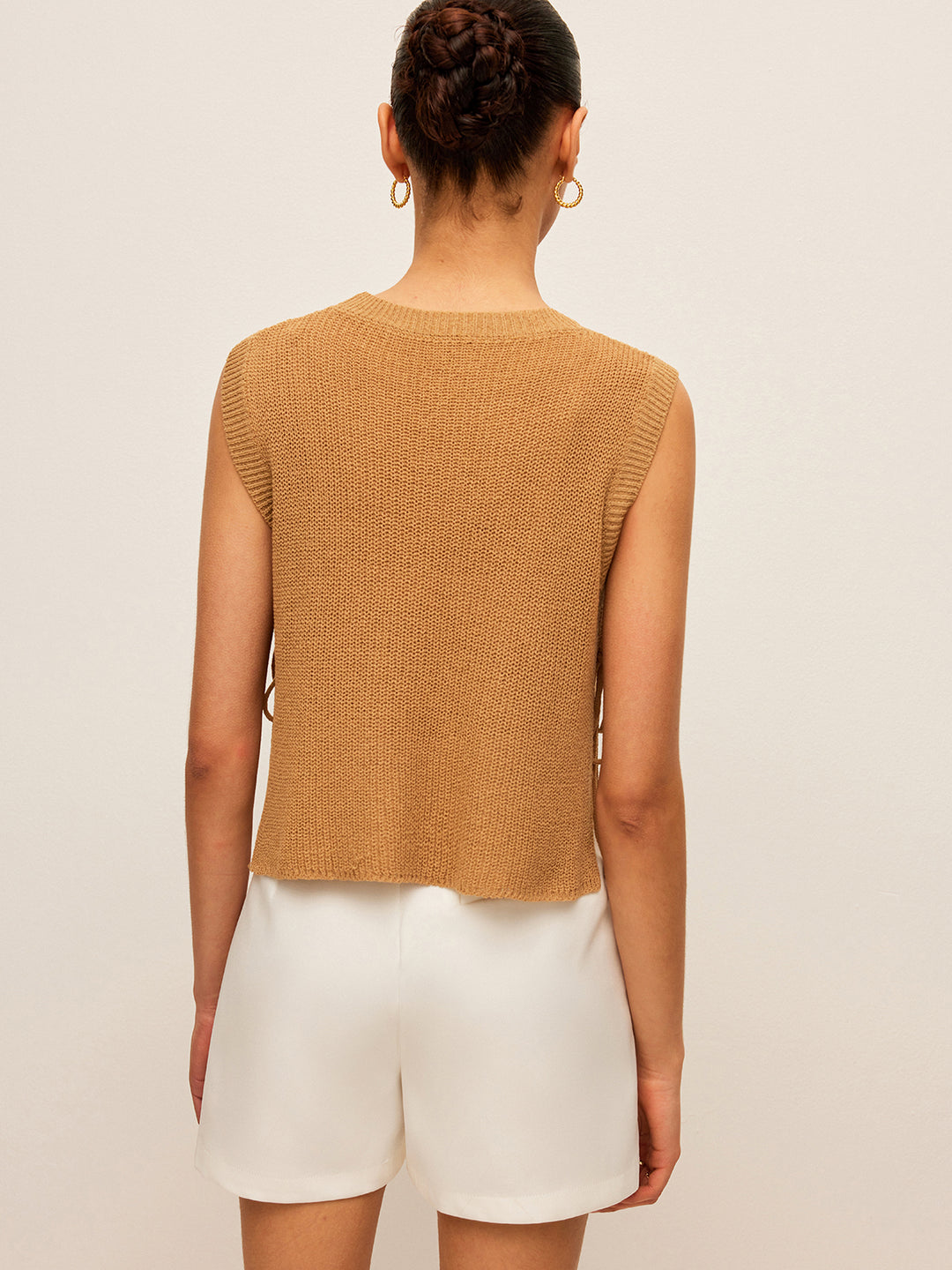 Beige knit sleeveless top with side lace closure