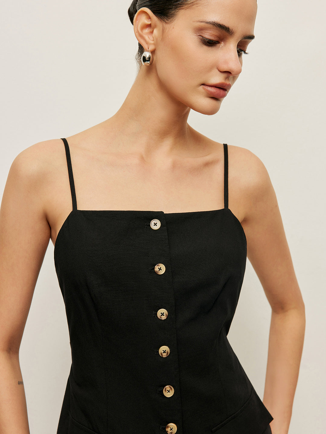 Black tank top with buttons and pocket details