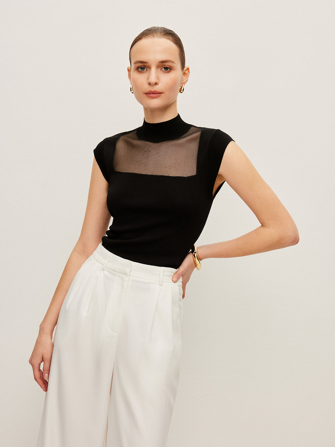 Sleeveless top with mesh details and high neck