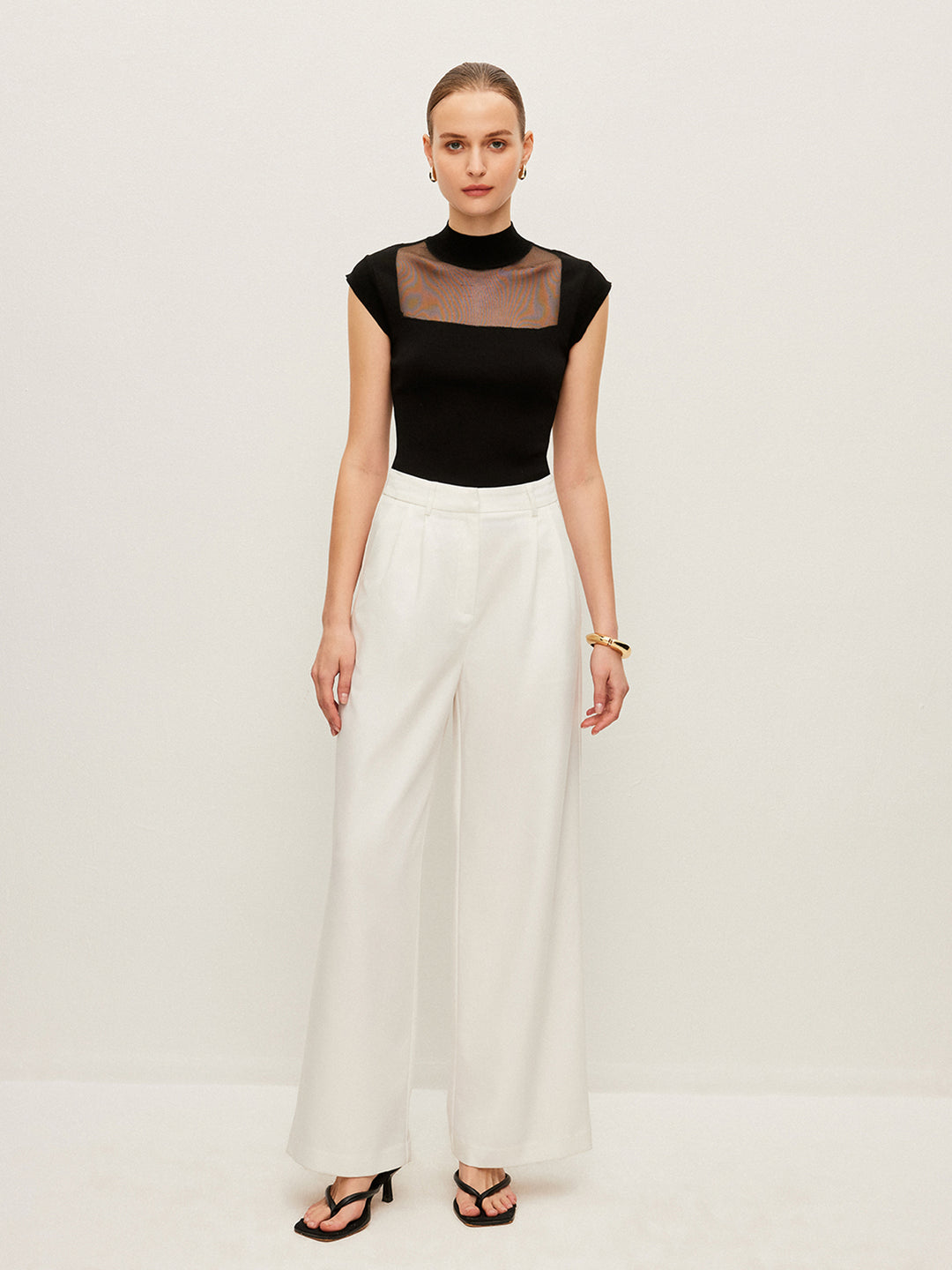 Sleeveless top with mesh details and high neck