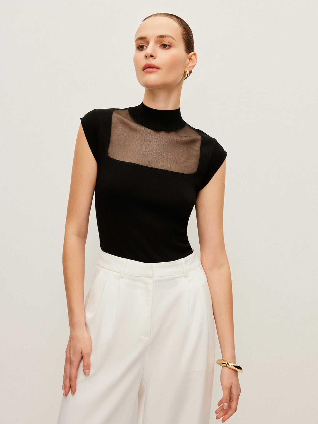Sleeveless top with mesh details and high neck