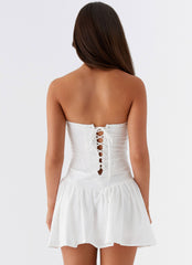 White strapless mini dress with ruffled skirt