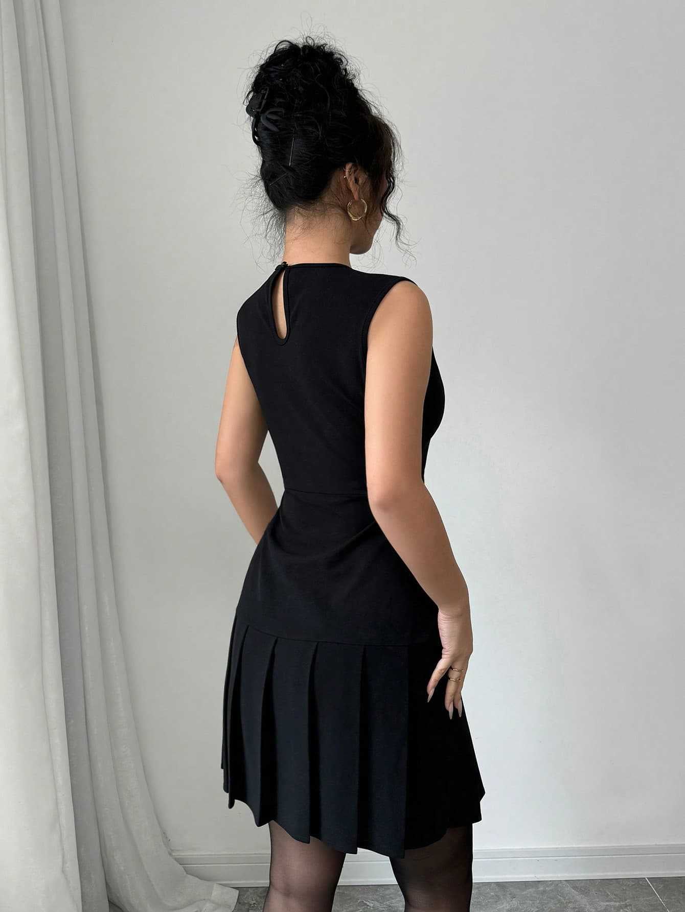 Black sleeveless mini dress with pleated skirt